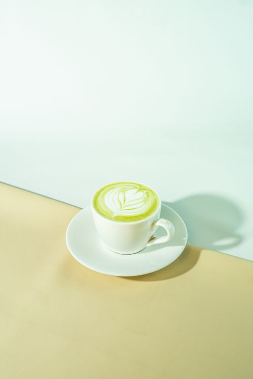 Hot matcha latte recipe served in a white cup with leaf-shaped foam art